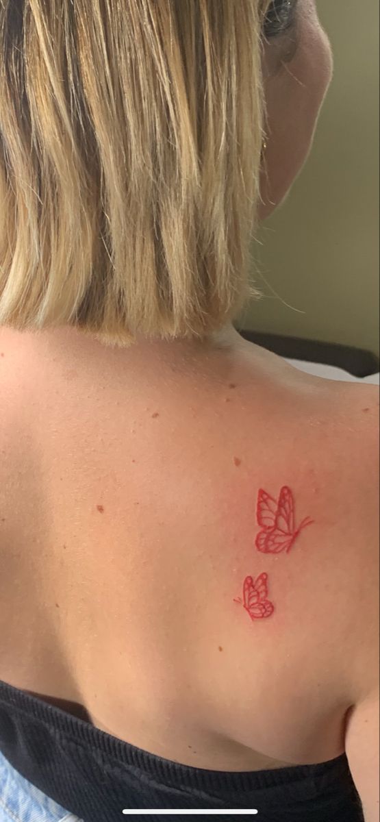 a woman with a butterfly tattoo on her back