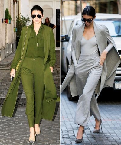 two women in green outfits walking down the street, one wearing sunglasses and the other wearing grey