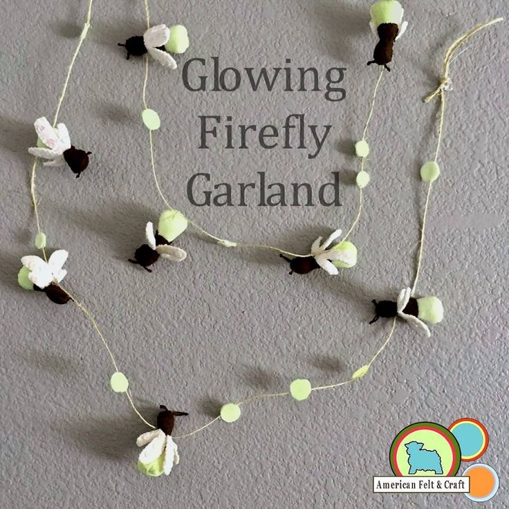 there is a string of flowers on the wall with words glowing firefly garland above it