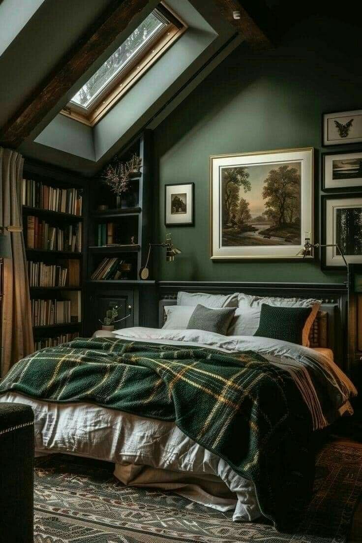 a bed sitting under a window in a bedroom next to a book shelf filled with books