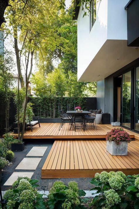 a wooden deck surrounded by plants and trees