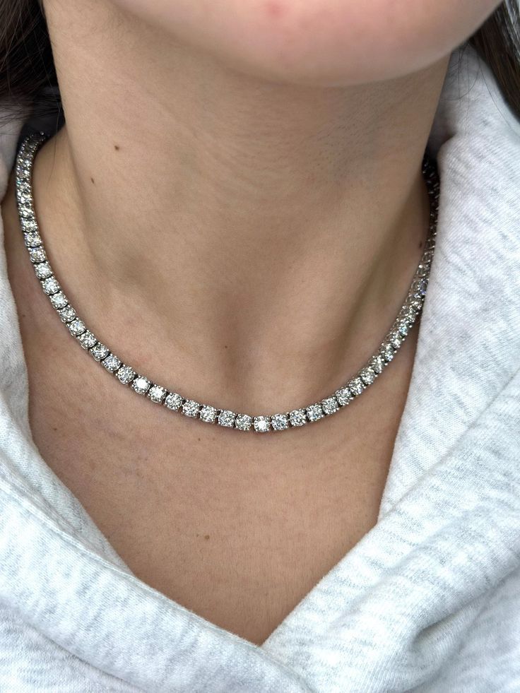 A classic piece, the 20CT T.W 4 Prong Lab Grown Diamond Tennis Necklace is made of 14K White Gold. Its adaptable design makes it look good with any outfit, guarantees durability, and helps the environment. This Tennis Necklace is Made in Los Angeles's Historic Jewelry District, and all Diamonds are Graded by a GIA Certified Gemologist. Stone Type: Lab Grown Diamonds Carat: 20CT T.W. Shape: Round - 4 Prong Color: F Clarity: VVS1 Cut: Excellent Chain Length: 16 inches Please Note: We can customize any chain to your desired length, please contact us to adjust the chain. Tennis Chain Necklace Women, Tenis Necklace, Tennis Necklace Diamond, Historic Jewelry, Diamond Tennis Necklace, Tennis Chain, Engagement Rings Bridal Sets, Tennis Necklace, Diamonds And Gold