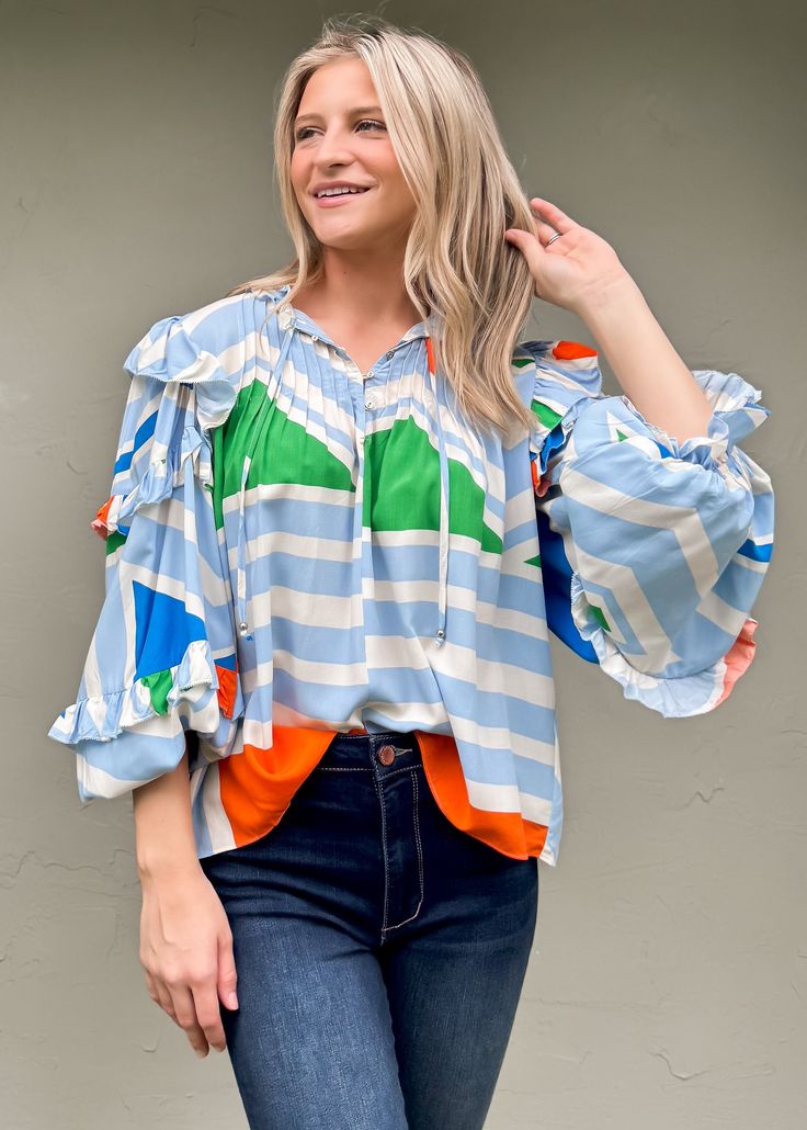 Upgrade your summer wardrobe with our Multi Geometric Ruffle Sleeve Top from Karlie. Featuring a fun and vibrant print, this top will add a touch of playfulness to your outfit. Made for the season, its lightweight fabric will keep you cool and stylish. True to size Olivia is 5'7 wearing small Color: Cream, Blue, Green, and Orange Ruffle Detail Button detail at neckline with ties Not lined 100% Rayon Fabric will shrink in washer - Dry Clean Recommended Ruffle Sleeve Top, Floral Dress Casual, Black Short Dress, Ruffled Sleeve Top, Rayon Fabric, Dressy Casual, Dress With Cardigan, Casual Blouse, Floral Dress Black