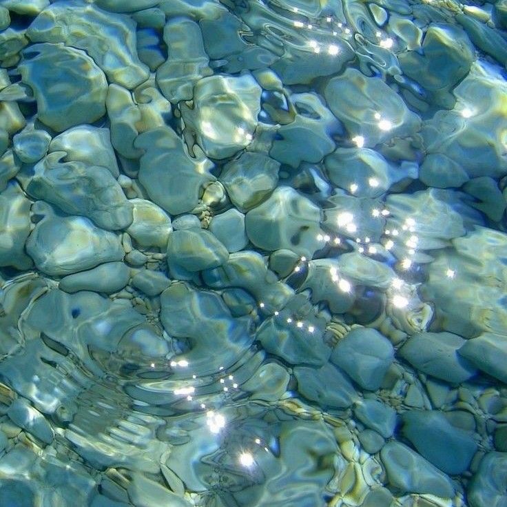 the water is crystal blue and clear with rocks in it, as well as bubbles