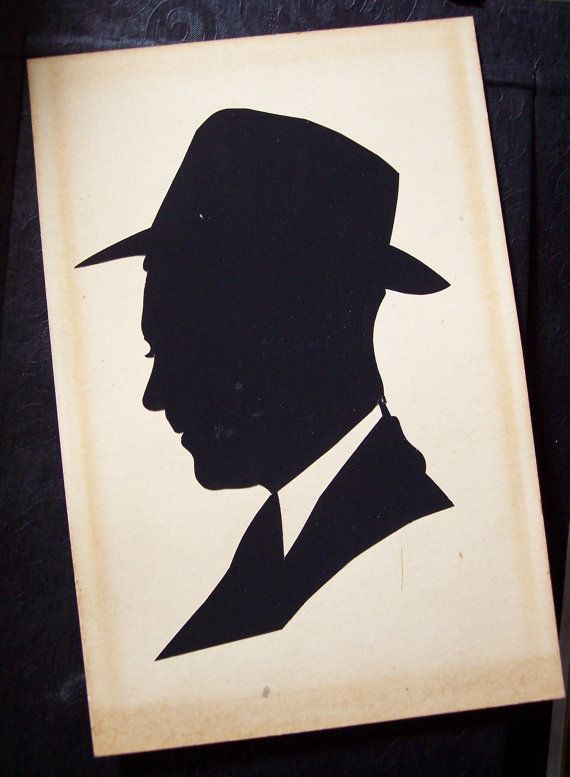 a black and white silhouette of a man wearing a hat