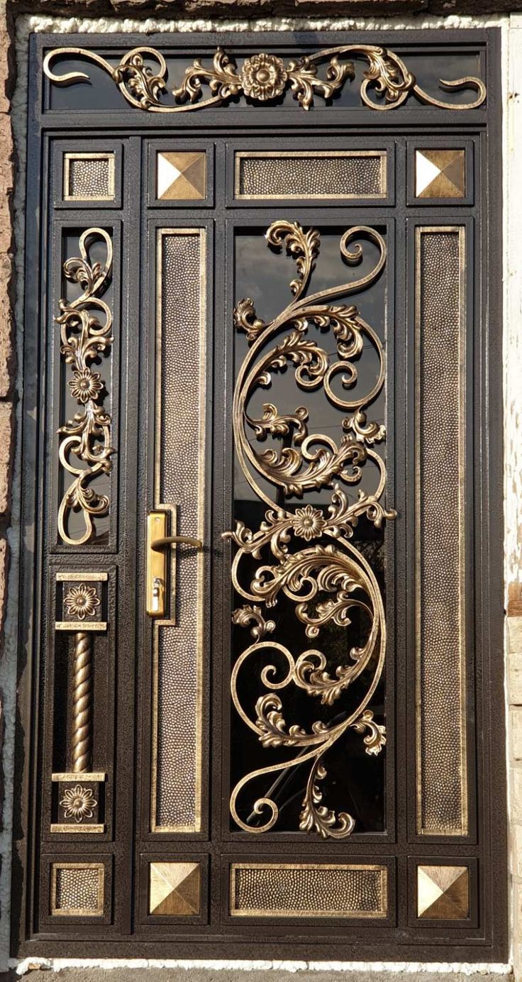 an ornate iron door with decorative designs on it