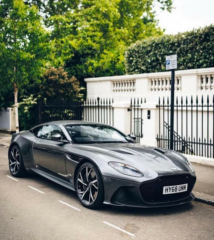 a grey sports car parked on the side of the road