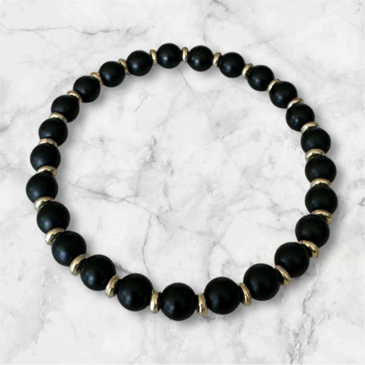 Indulge in a touch of luxury with our Black Onyx Gemstone Bead Stretch Bracelet. This elegant bracelet features beautifully smooth and polished black onyx gemstone beads, creating a timeless and sophisticated look. Perfect for any occasion, this bracelet adds a touch of glamour and refinement to any outfit. Luxury Black Beads Bracelets, Elegant Polished Black Beads, Elegant Black Polished Beads, Elegant Obsidian Jewelry With Polished Beads, Elegant Black Beads For Formal Occasions, Black Crystal Bracelet With Spacer And Round Beads, Black Crystal Bracelet With Spacer Beads, Onyx Crystal Bracelet With Black Round Beads, Black Gemstone Bead Bracelet