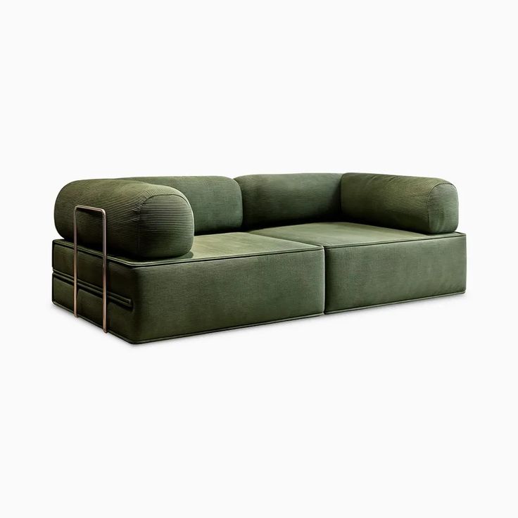 a green couch with two pillows on it's back and the seat folded down