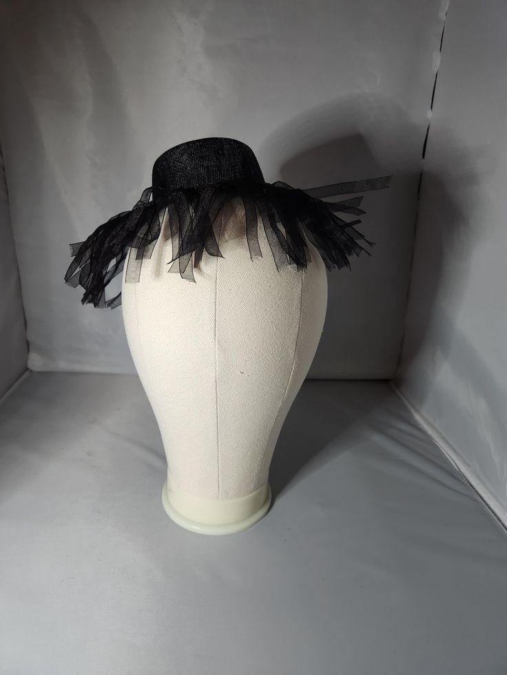 This flapper-inspired hat fastener is simply and fun.  Perfect for Halloween or any Gothic occasion,  this hat can be worn in a variety of ways to add spice to most any outfit. Gatsby Style Wide Brim Party Hat, Gatsby Wide Brim Party Hat, Black Fedora Halloween Costume Hat, Adjustable Black Top Hat For Halloween, Black Fedora For Halloween, Black Novelty Mini Hats For Costume Party, Gatsby Style Adjustable Costume Hats For Kentucky Derby, Halloween Costume Adjustable Fascinator, Adjustable Gatsby Costume Hats For Kentucky Derby