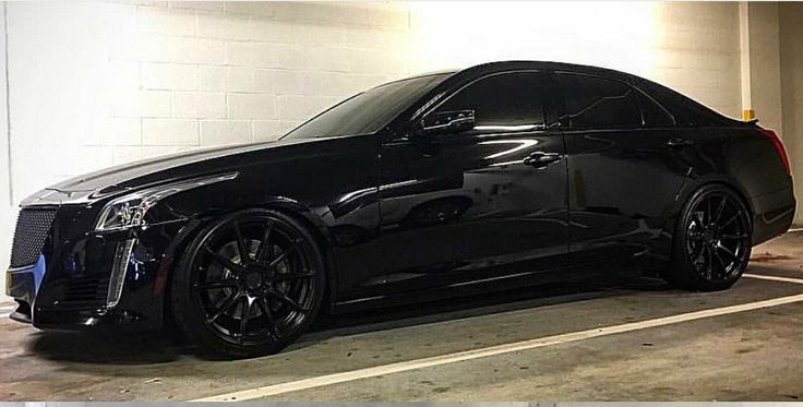 a black car parked in a parking garage