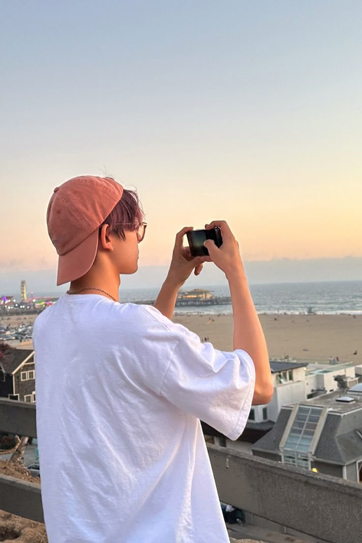 a man standing on top of a roof looking at the sky with a pair of binoculars