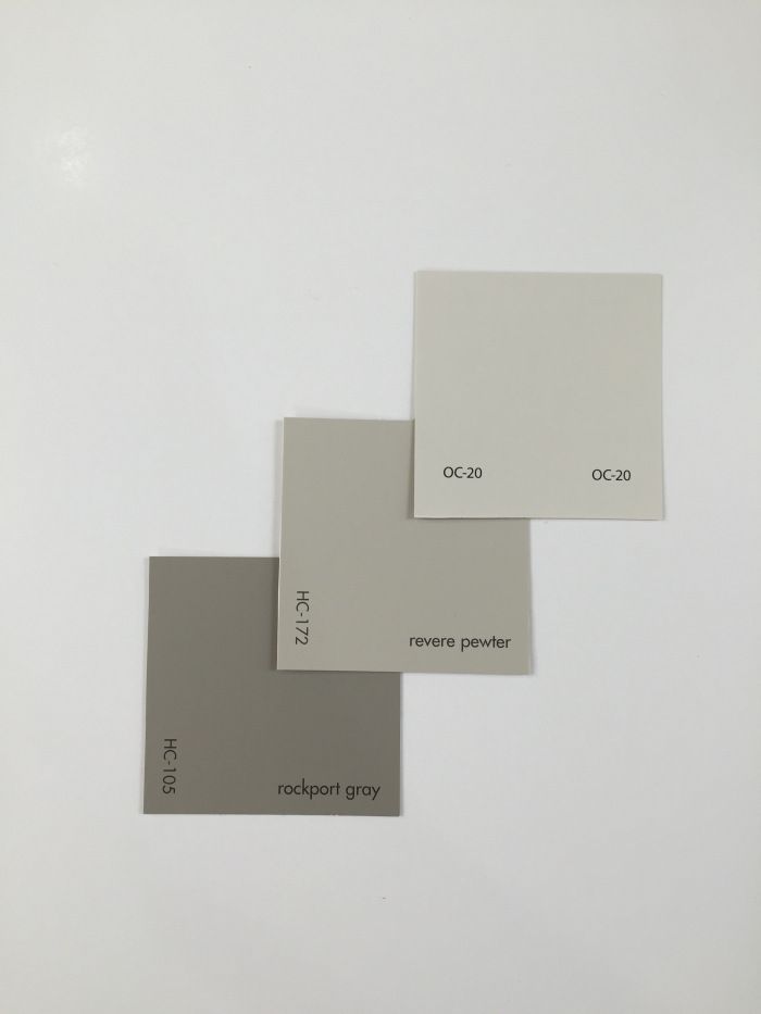 three different shades of paint on a white surface, one gray and the other light grey