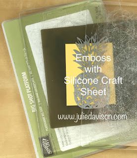 two envelopes sitting next to each other on top of a wooden table with the words emboss with siloone craft sheet