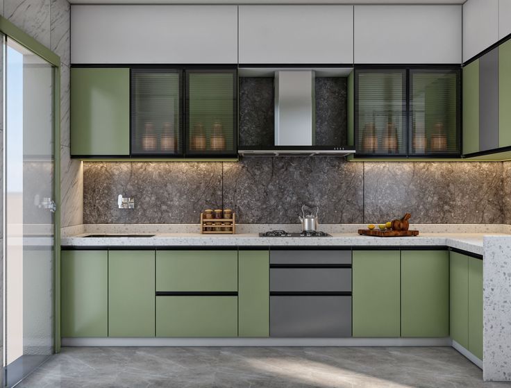 a modern kitchen with green cabinets and marble counter tops, along with stainless steel appliances