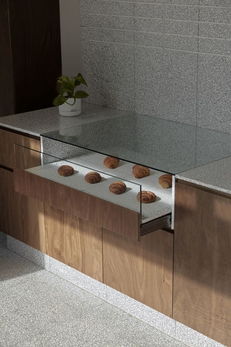 some cookies are sitting on top of a glass shelf in front of a countertop