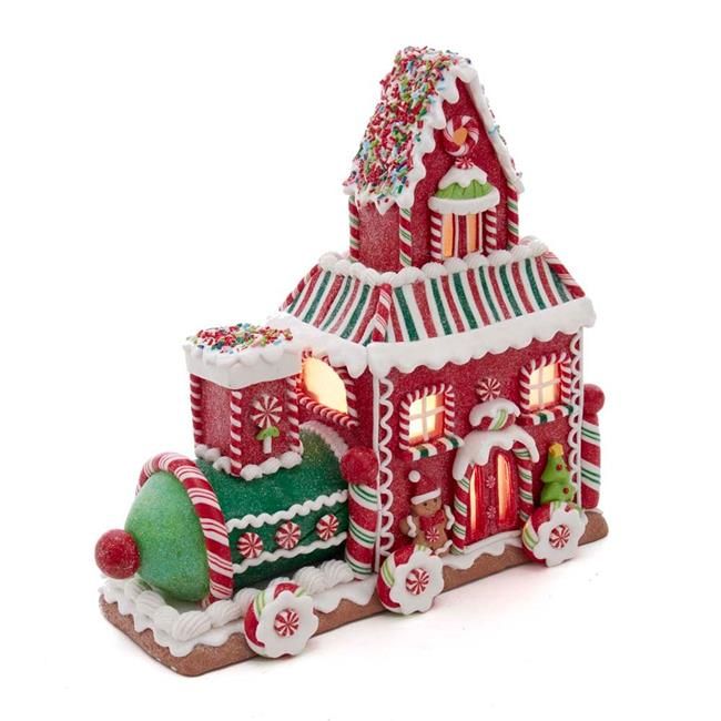 a red and white gingerbread house with lights