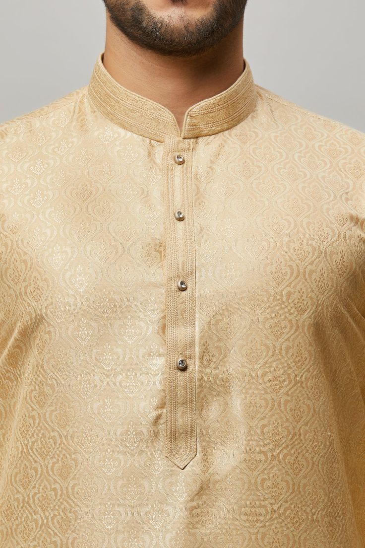 Brocade Kurta with gold embossing & placket plus gold churidar Crafted with a collar neckline, full sleeves, and front button closure. Occasion: Can be worn to lighter events like Sangeet, Mehendi, Puja, or a small party WASH CARE INSTRUCTIONS - Please Dry clean only when it is applicable. Slight color variation is possible due to digital photography. Brocade Mens Kurta, Traditional Fitted Kurta With Band Neckline, Wedding Long Sleeve Bandhgala With Zari Weaving, Wedding Bandhgala With Zari Weaving And Long Sleeves, Elegant Kurta With Band Neckline For Festive Occasions, Elegant Straight Kurta With Zari Weaving, Festive Elegant Kurta With Band Neckline, Elegant Festive Kurta With Band Neckline, Unstitched Gold Churidar For Transitional Season