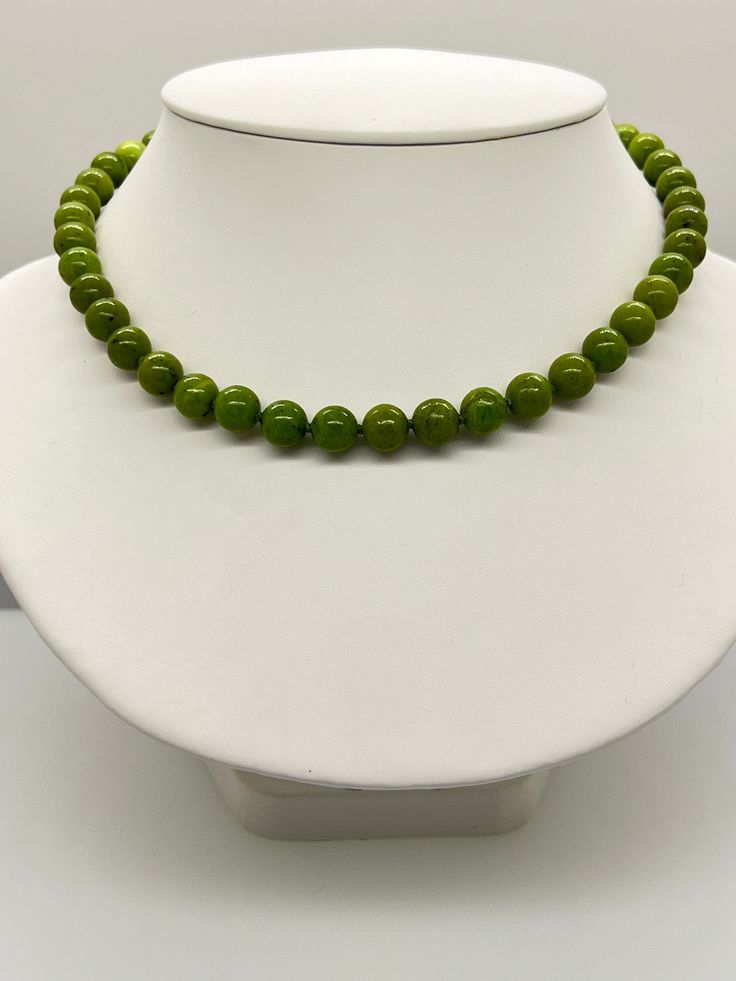 Green Canadian Jade Bead Necklace.   This hand knotted necklace features 43 Green Canadian Jade Beads Round Polished 9.1 to 10.1mm.  I hand knotted these with silk thread and finished them with a 925 silver Round polished bead clasp 10mm.  The necklace measures 18 inches in length.  These are Genuine Canadian Jade beads and they are natural in color, no treatments.  The necklace pictured is the one you will receive.  Please visit our shop for more pearls and gemstone jewelry. Luxury Jade Emerald Necklace With Round Beads, Green Pearl Necklace With Gemstone Beads, Green Pearl Necklace With Round Gemstone Beads, Single Strand Pearl Necklace With Round Beads, Green Single Strand Pearl Necklace With Round Beads, Green Pearl Necklace With Polished Round Beads, Green Hand Knotted Round Beads Jewelry, Green Hand-knotted Round Beads Necklace, Adjustable Pearl Necklace With Gemstone Beads