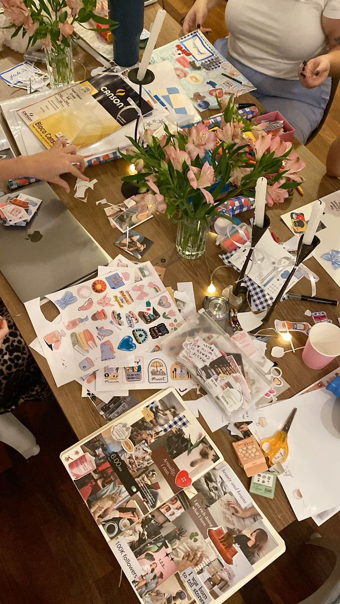 people sitting at a table with pictures and flowers