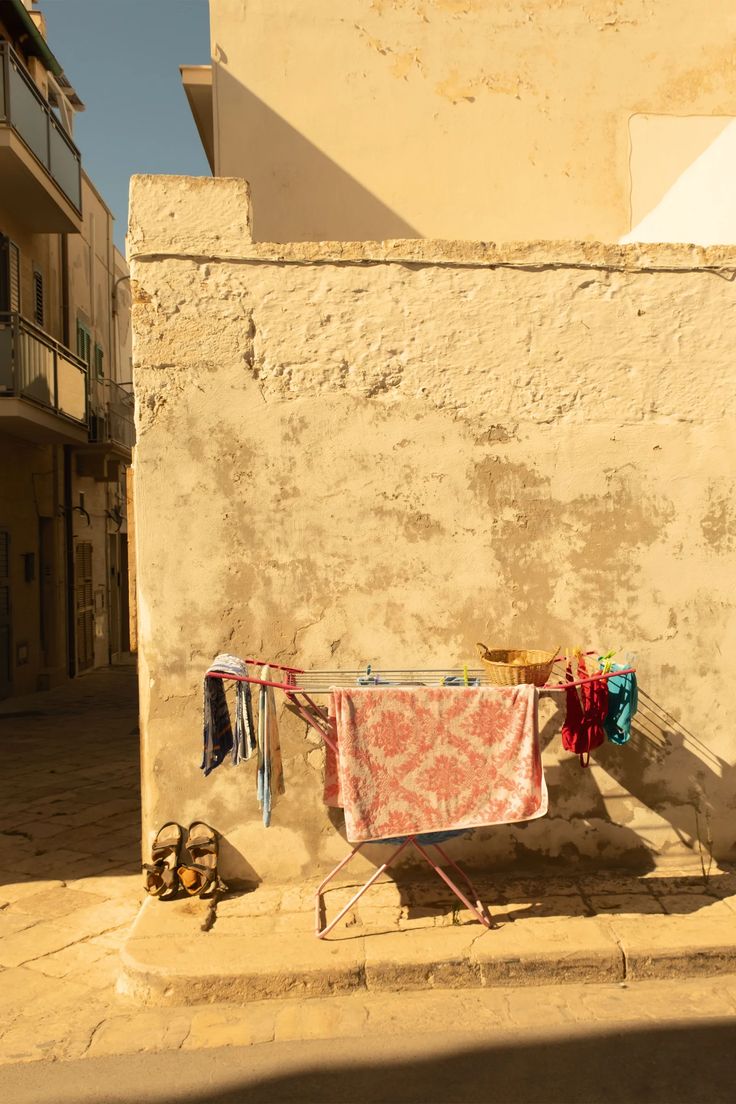 clothes hanging out to dry in front of an old building with balconies on the side