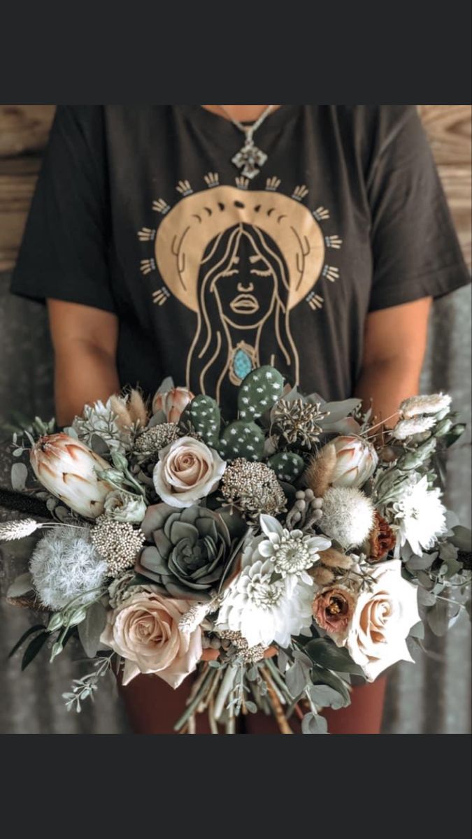 a woman holding a bouquet of flowers in her hands