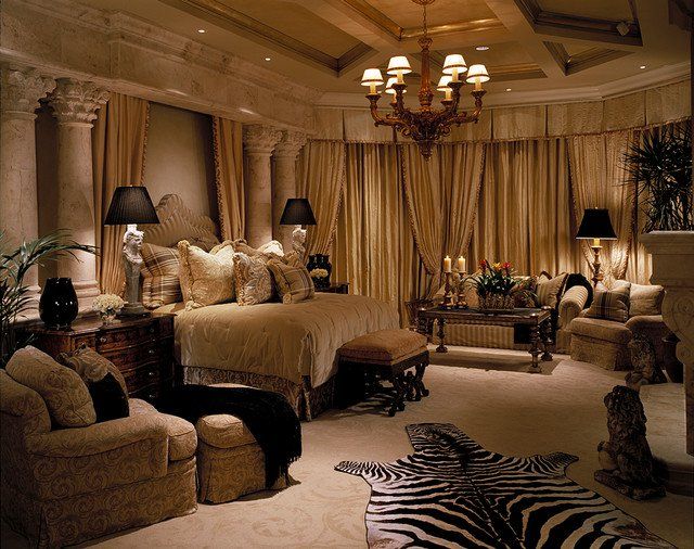 a bedroom with zebra rugs and chandelier in the corner, along with two couches