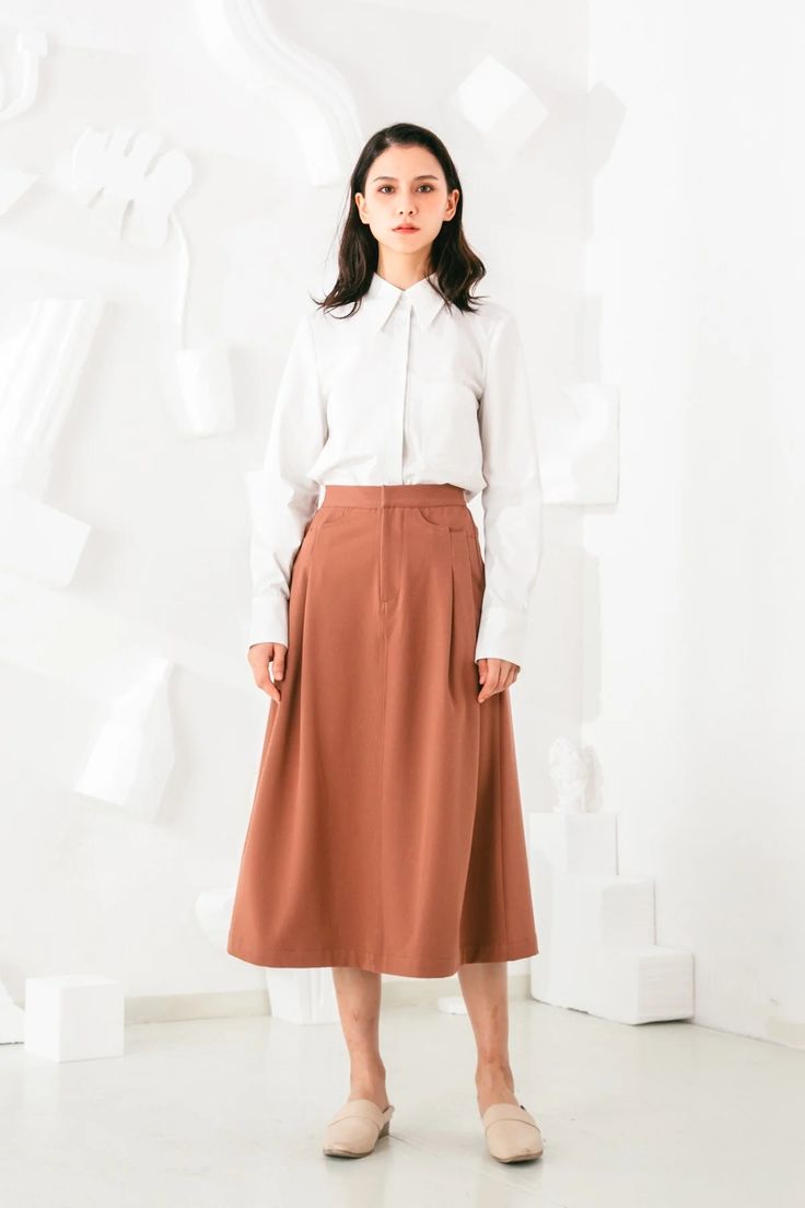 Invest in a timeless wardrobe staple with our chic Aurelie Midi Skirt. Its simple yet elegant silhouette is highlighted by elongating vertical pleats and a flattering A-line shape. Wear yours with feminine blouses and sleek outerwear. Vertical pleats create an elongated silhouette Elastic waist for all day ease and com Chic A-line Maxi Skirt For Work, Elegant A-line Pleated Skirt For Daywear, Chic Flared Maxi Skirt For Work, Chic Workwear Flared Maxi Skirt, A-line Skirt For Workwear In Fall, Elegant Pleated Maxi Skirt For Office, Elegant A-line Maxi Skirt For Work, Elegant Office-style Pleated Maxi Skirt, Fitted Pleated Maxi Skirt For Work