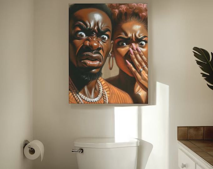 a bathroom scene with focus on the toilet and two people's faces painted on the wall