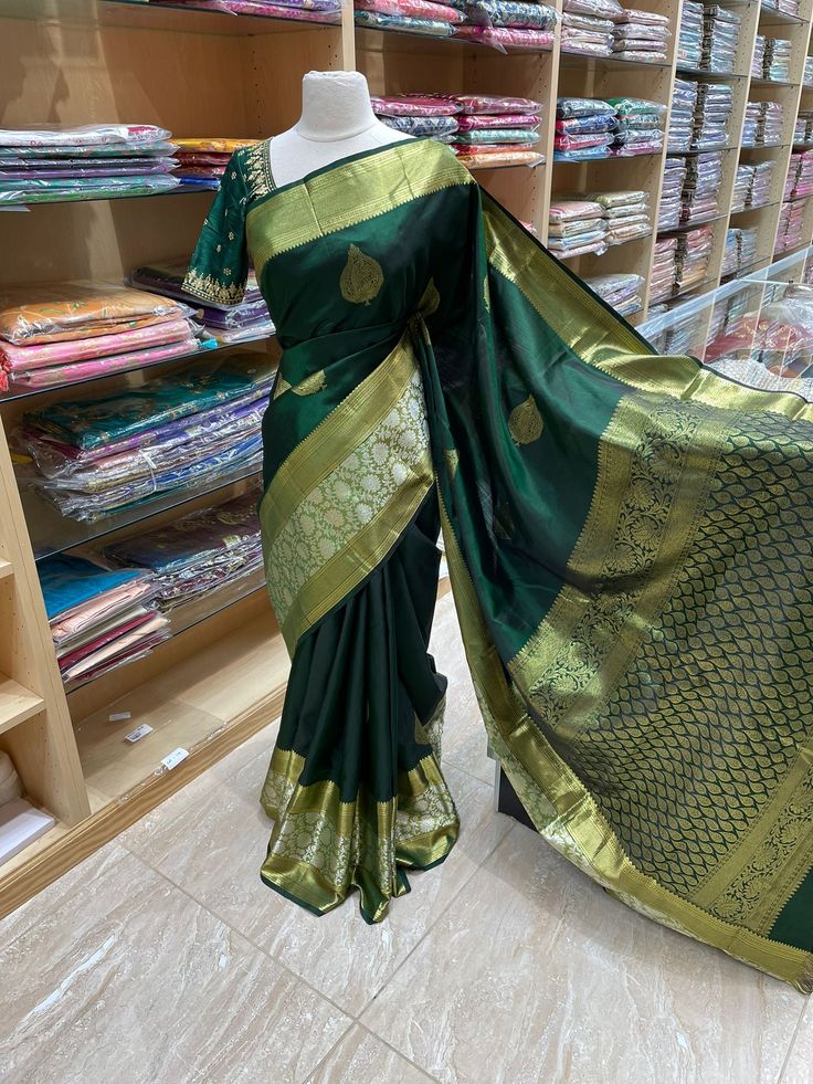 Feel beautiful and stylish in this traditional Kanjeevaram Silk Saree NK-001! Featuring bold floral designs on ultra-soft fabric, this luxurious saree is designed to make you feel like royalty. Perfect for special occasions, it's a timeless classic that will make you shine. Elegant Paithani Silk Pre-draped Saree For Designer Wear, Designer Festive Banarasi Silk Saree, Designer Green Pre-draped Saree With Meenakari, Elegant Meenakari Pre-draped Saree, Elegant Fitted Meenakari Saree, Elegant Pre-draped Meenakari Saree, Elegant Fitted Traditional Wear With Meenakari Details, Elegant Fitted Traditional Wear With Meenakari, Designer Green Saree With Zari Weaving