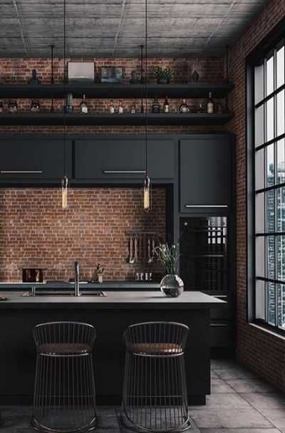 an industrial style kitchen with brick walls and black cabinets, bar stools, and stainless steel appliances