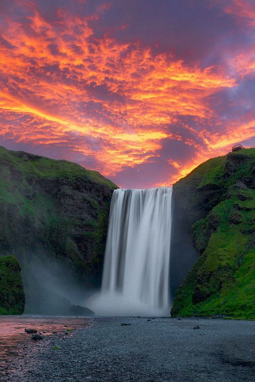 the sun is setting over a waterfall and it looks like it has just been taken off