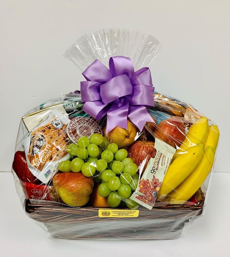 a basket filled with lots of different types of fruits and snacks on top of a table