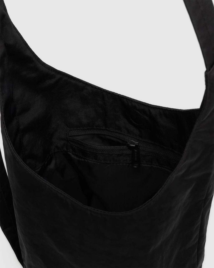 A slouchy, softly structured nylon bag with an adjustable strap. Interior zip pocket with a magnetic closure. The details- Heavyweight nylon (59% recycled) 9.5 in. H × 7 in. W × 4.25 in. D 39 in. adjustable strap Machine washable Nylon Hobo Shoulder Bag With Zipper Pocket, Black Nylon Hobo Bag With Adjustable Strap, Nylon Crossbody Hobo Bag With Zipper Closure, Functional Nylon Hobo Bag With Removable Pouch, Functional Nylon Hobo Shoulder Bag, Functional Nylon Hobo Bag With Adjustable Strap, Functional Nylon Hobo Bag, Functional Nylon Shoulder Bag With Adjustable Straps, Functional Hobo Bag With Adjustable Strap