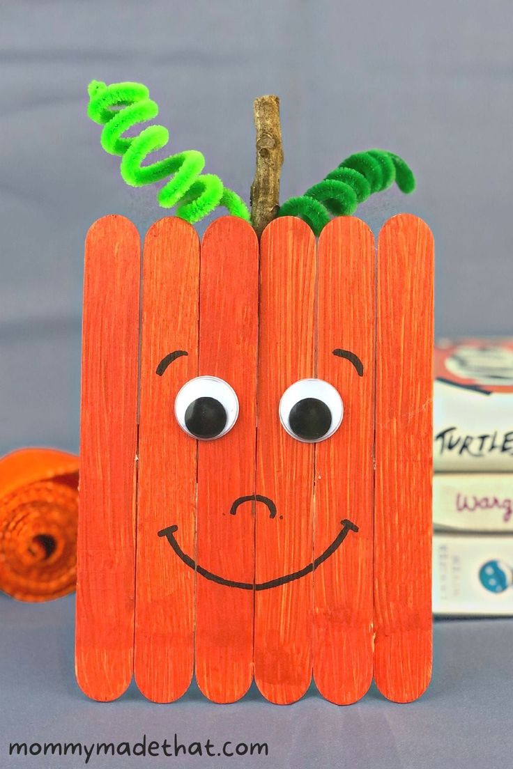 a carrot with eyes and nose made out of wood sticks