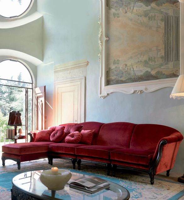 a living room filled with furniture and a painting on the wall