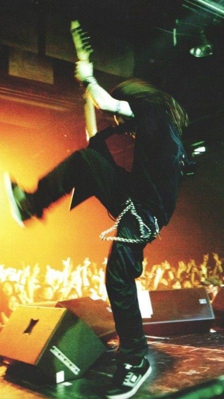 a skateboarder is doing tricks on his board in front of an audience at a concert