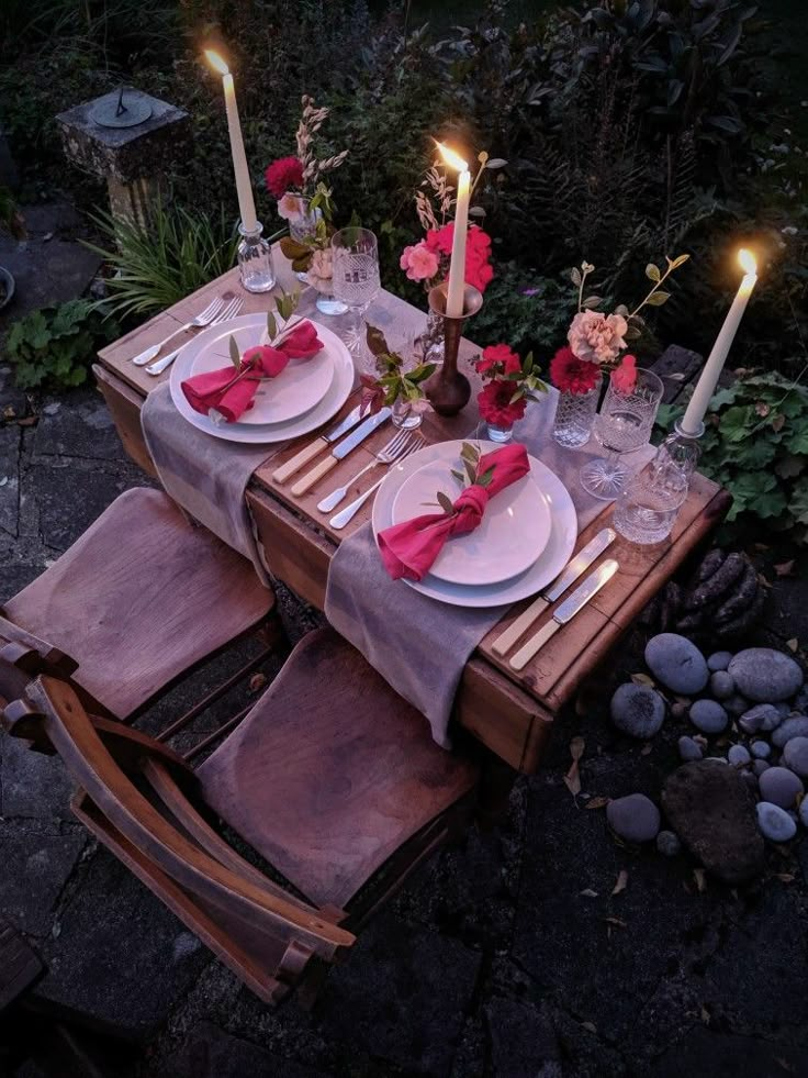 the table is set with plates and candles