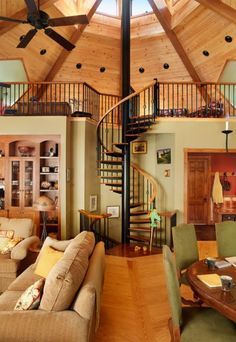 a living room filled with furniture and a spiral staircase