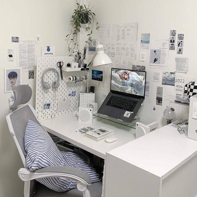 a laptop computer sitting on top of a white desk