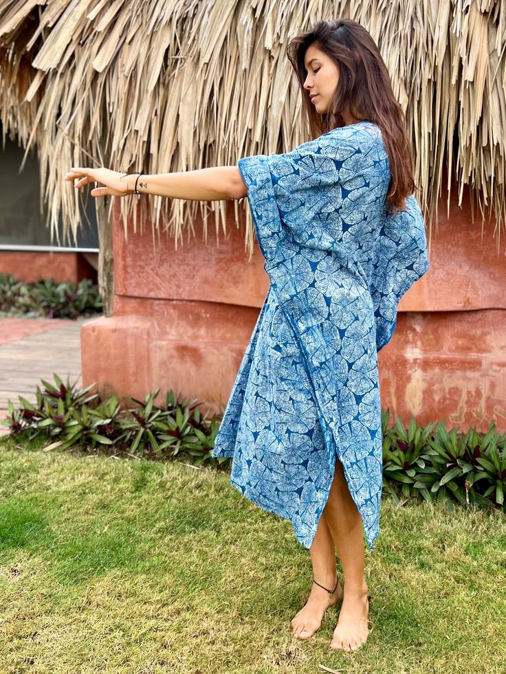 Beautiful Indigo 100% Cotton Caftan Dress with Japanese style print. This dress with an incredible crisp print is an amazing addition to any bohemian or spiritually inclined wardrobe. Perfect morning festival dress or a special ritual attire for an intentional gathering. Size: One sizeOveral Length: 46 in. Overal Width: 44 in.Material: 100% cotton, indigo dyed and hand-block printed by our friends, the local artisans in Bagru village, Rajasthan, India. It is a dress that can be used for gatherin Bohemian Block Print Kimono For Vacation, Bohemian Block Print Kimono For Summer, Traditional Summer Batik Print Kimono, Bohemian Ikat Print Kimono For Summer, Bohemian Block Print Summer Kimono, Bohemian Ikat Print Kaftan For Beach, Bohemian Ikat Print Maxi Dress For Beach, Ikat Print Kaftan With Kimono Sleeves For Beach, Summer Long Ikat Print Kaftan