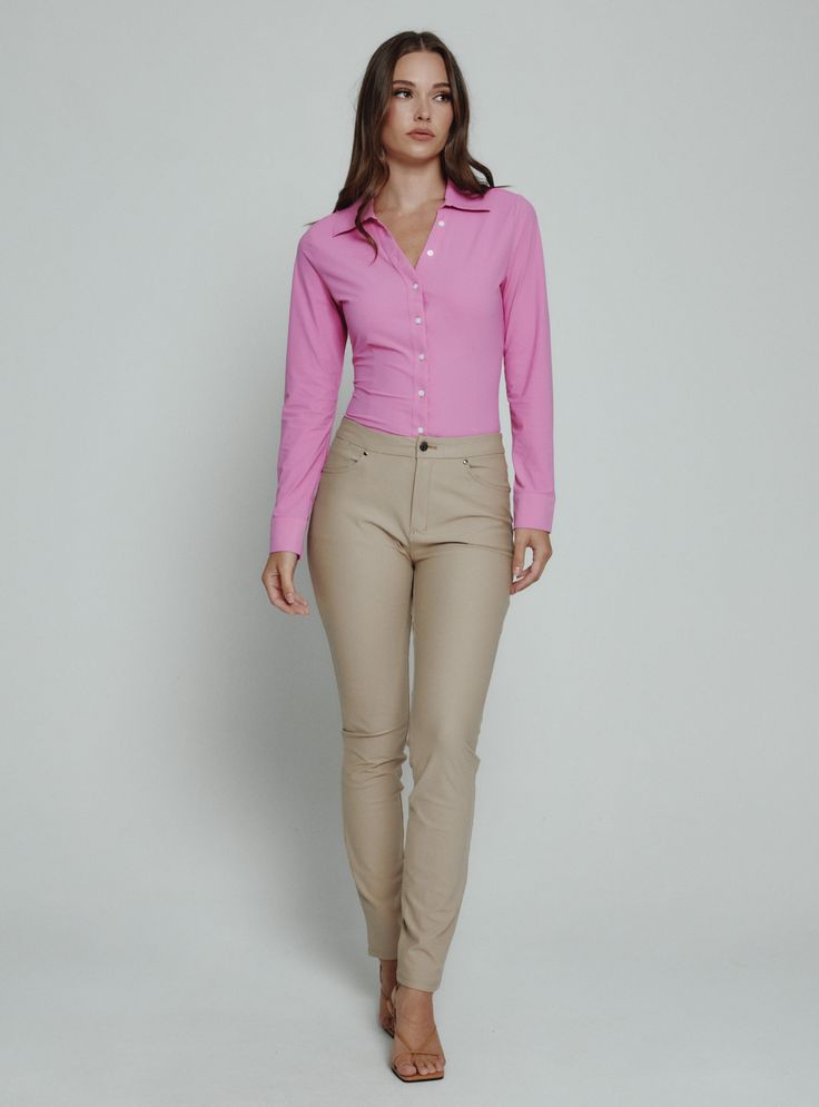 The Luxe Blouse features 4-Way Stretch fabrication that is both moisture-wicking and wrinkle free. This is a flattering semi-fitted blouse designed with mother of pearl buttons for a sophisticated look. Perfect for the office or a fancy dinner on the weekend. Details Model is 5'10" and wears a size small. Care: Machine wash cold on delicate cycle with similar colors. Do not bleach. Dry flat. Do not dry clean. Cold hand wash for best results. Composition: 78% Nylon | 22% Spandex Stretch Blouse With Button Closure For Office, Office Blouse With Button Closure And Stretch Fit, Stretch Button-up Blouse For Business Casual, Business Casual Stretch Button-up Blouse, Fitted Blouse For Business Casual, Fitted Professional Blouse, Fitted Professional Blouse For Business Casual, Professional Fitted Blouse For Workwear, Fitted Button-up Blouse For Professionals