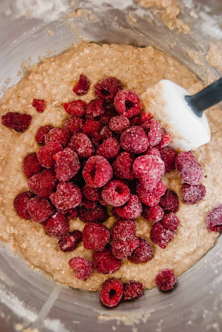 a bowl filled with oatmeal and raspberries