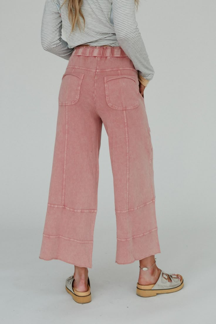 You can never have enough cozy wide leg pants and the Lucky One Wide Leg Pant is no exception! Feel comfy and put together with little effort in these because they feature: Comfortable, medium - weight, knit fabric Elastic drawstring waist for the perfect fit Wide leg silhouette for a relaxed look Side, back, and cargo style pockets Exposed seams with raw edges throughout for added boho style Comfy cute boho outfit pair with: Sophie Crochet Lace Bralette, Scoop Neck Bralette Tee, Bandit Buckle S Fall Wide Leg Pants With Drawstring And Relaxed Fit, Comfortable Straight Leg Bottoms With Drawstring, Comfortable Elevated Casual Bottoms, Relaxed Bottoms With Drawstring For Fall, Relaxed Drawstring Bottoms For Fall, Relaxed Fit Cozy Pink Pants, Pink Relaxed Fit Cozy Pants, Cozy Relaxed Fit Pink Pants, Comfortable Bottoms With Elastic Waistband