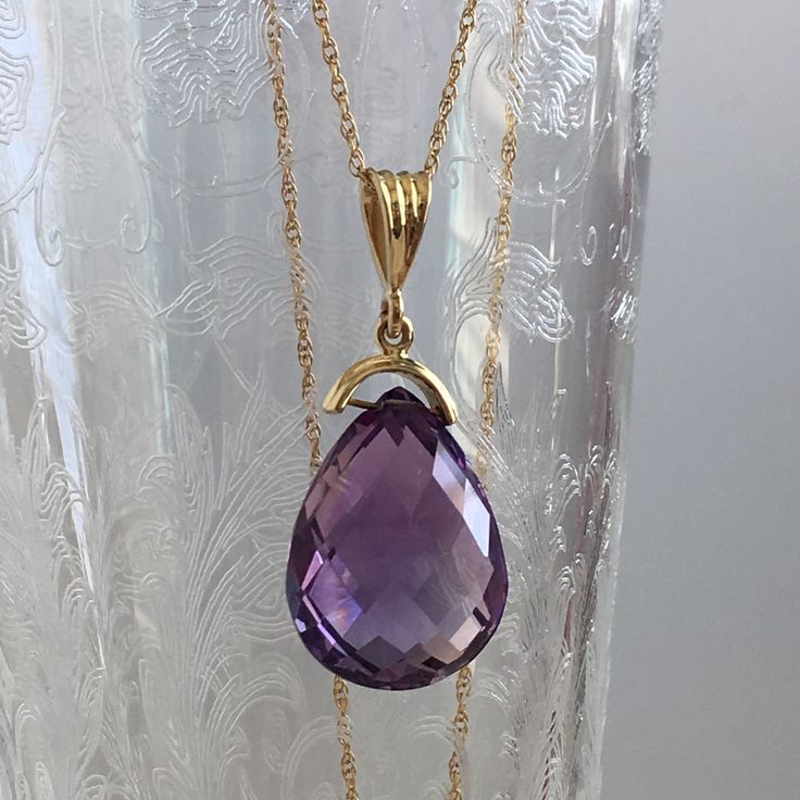 Details: Lovely vintage amethyst pendant and 14K gold necklace. The amethyst is faceted, and has an amazing sparkle glow. The amethyst measures 15.19 x 19.67 x 10.37mm, and is roughly 14.5 carats. This pendant is sold with a 14K gold chain, and the chain is modern. Please ask all necessary questions prior to placing an order! Size: The chain measures 16 inches, and the pendant is 1 1/4 inches. Condition: The overall all condition of this piece is very good. Purple Drop Necklace For Formal Occasions, Formal Purple 14k Gold Necklace, Formal Purple Drop Necklace, Formal Faceted Amethyst Necklace, Formal Drop Amethyst Necklaces, Formal Amethyst Drop Necklace, Formal Drop Amethyst Necklace, Teardrop Amethyst Necklace For Formal Occasions, Formal Teardrop Amethyst Necklace