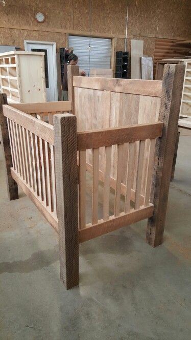 a wooden bed frame sitting inside of a building