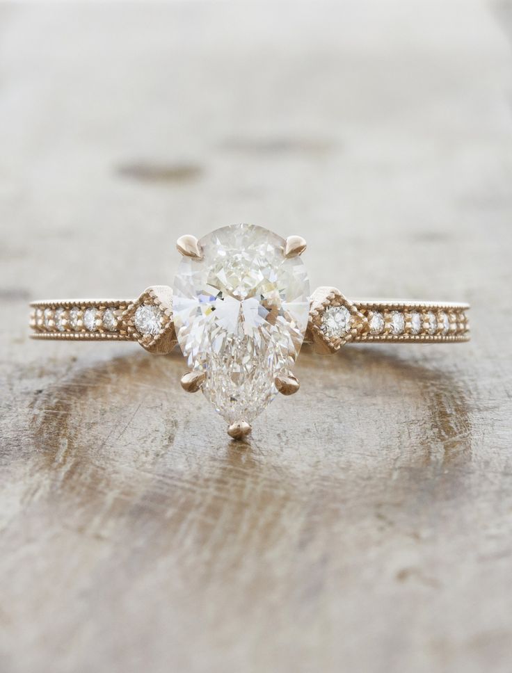 an engagement ring with a pear shaped diamond