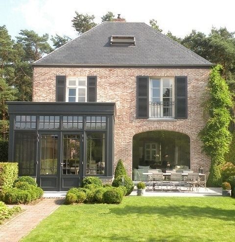 a large brick house with lots of windows