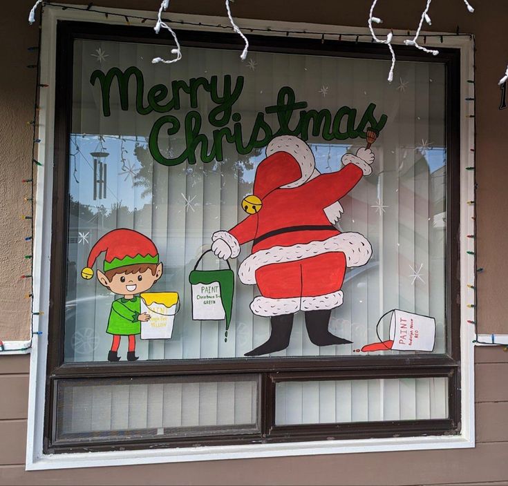 a store window with a christmas sign on it's front and santa clause in the window