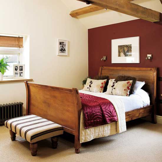 a bed room with a neatly made bed next to a window and a radiator